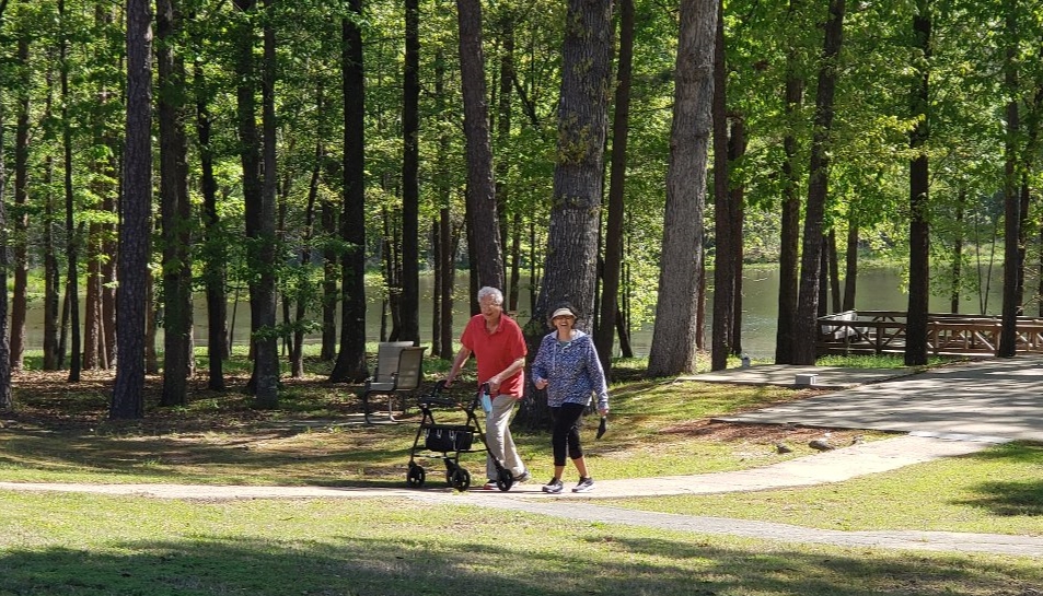 Residents enjoy a walk by the lake, an example of active Senior Living in Little Rock at Good Shepherd Community.