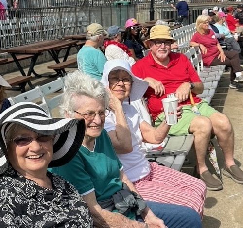 Seniors seated in a row at ballgame