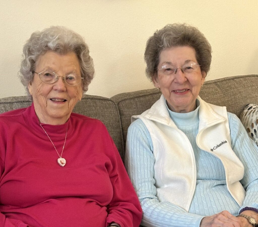 Two senior ladies sitting on couch