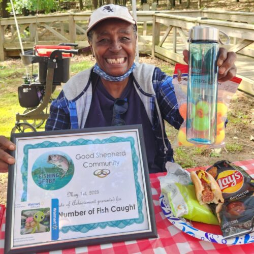 Woman holding award for catching the most fish