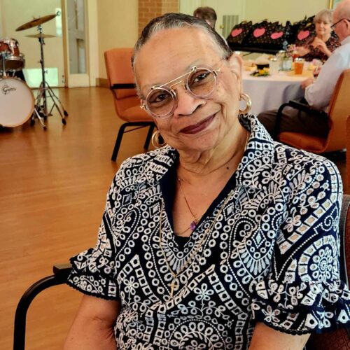 SENIOR LADY SEATED AND POSING FOR PHOTO