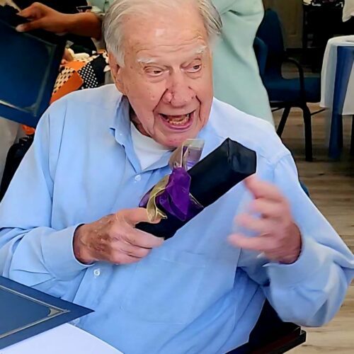Smiling senior man receiving a gift