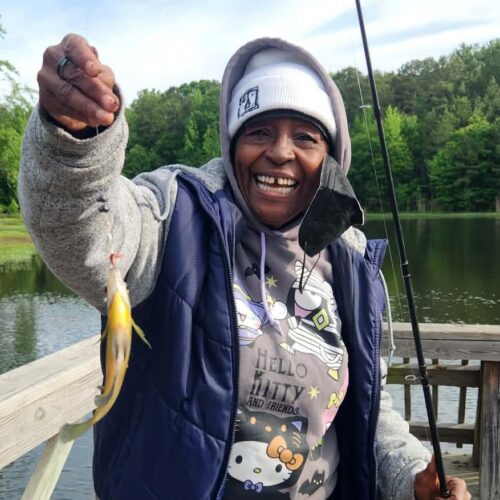 Happy resident catches fish at our independent living fishing derby at Good Shepherd Community.