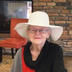 Senior woman in large white hat